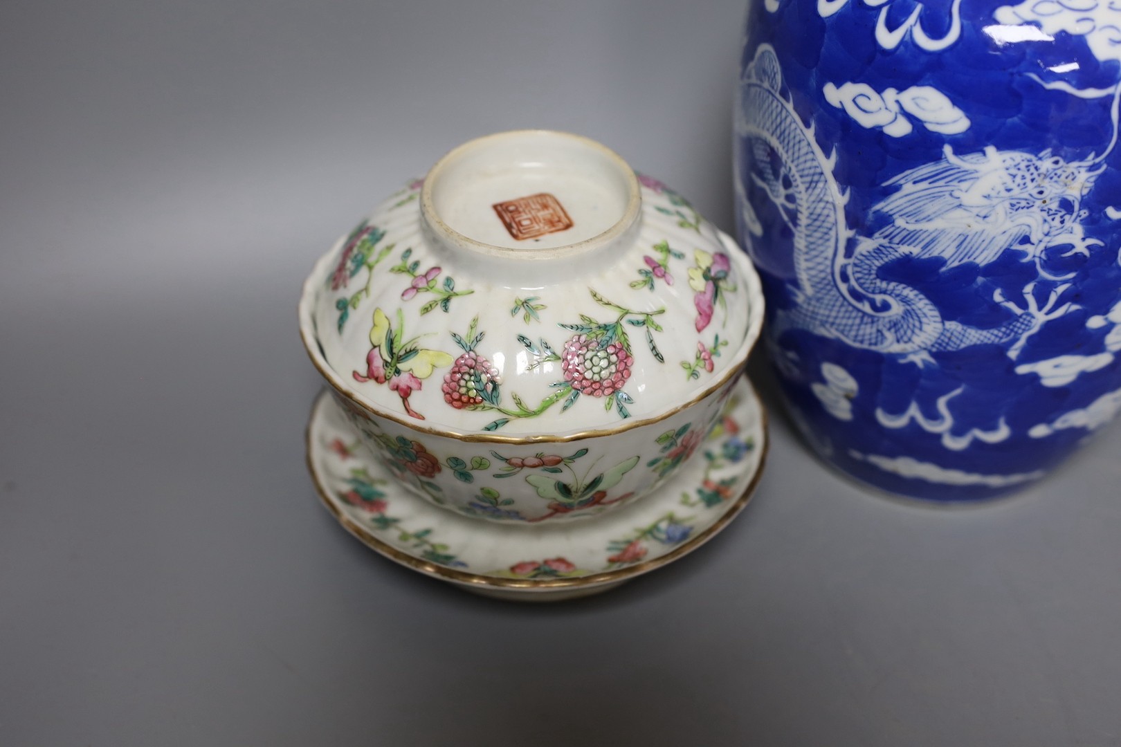 A 19th century Chinese famille rose rice bowl, cover and stand, together with a blue and white dragon jar and similar bottle vase. Largest 18cm